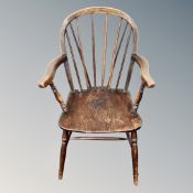 A 19th century elm and beech kitchen armchair