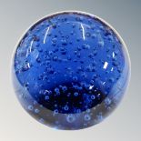 A large blue glass paperweight together with mirrored tray containing eight miniature ornaments,