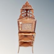A stained pine fretwork corner wall shelf cabinet together with a mahogany three tier curio table