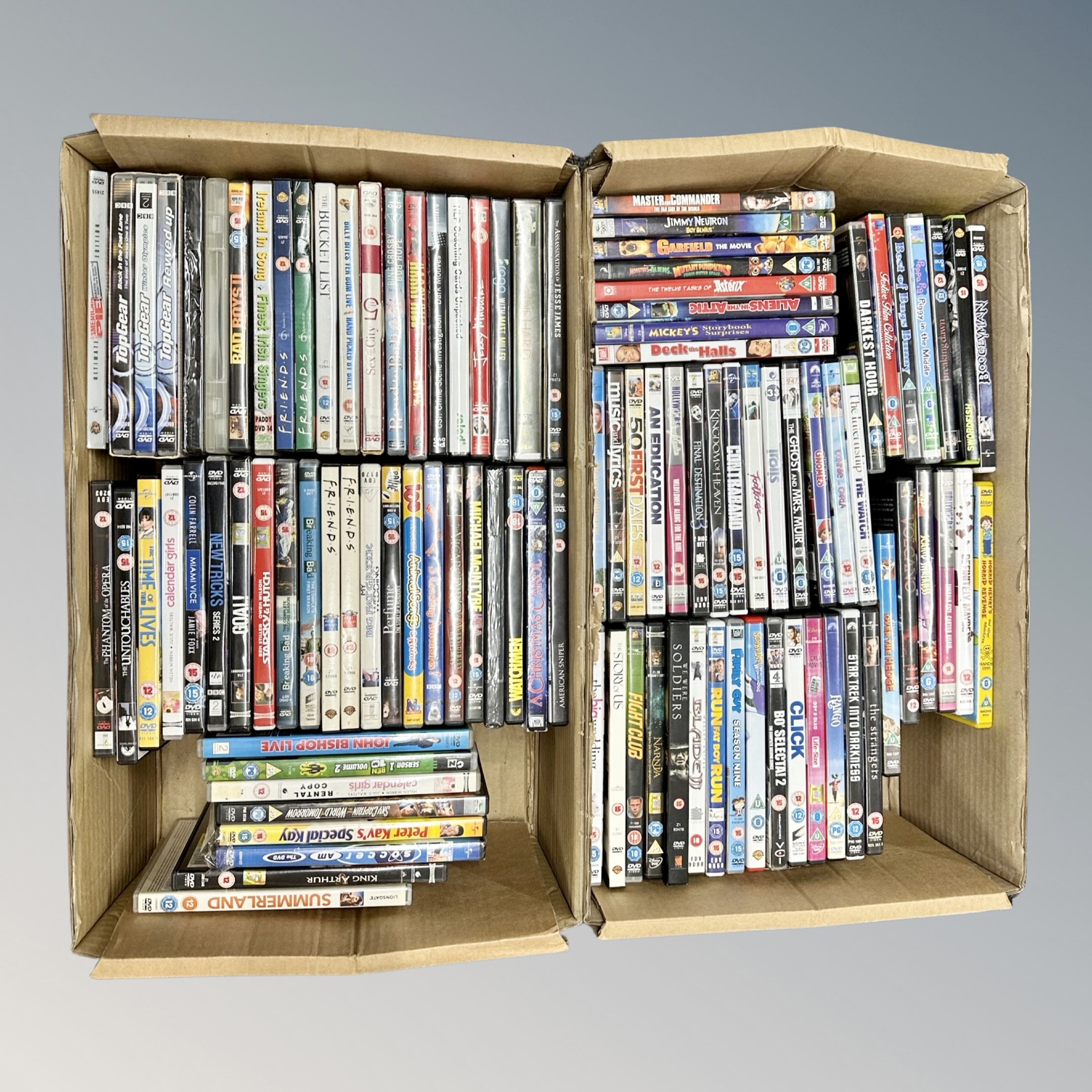 Two boxes containing approximately 100 dvds