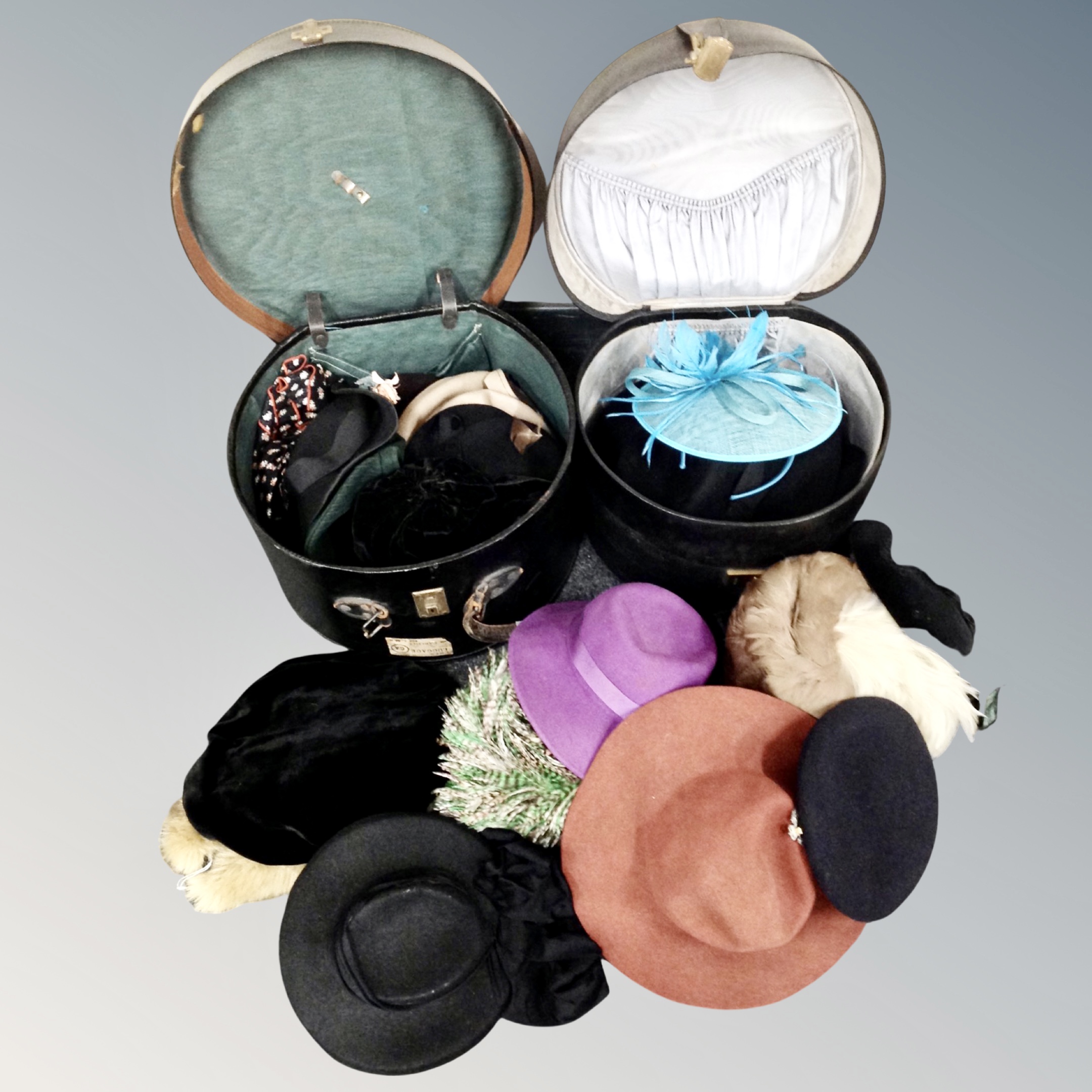Two vintage hat boxes containing assorted lady's hats