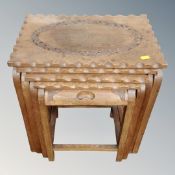 A nest of four carved tables
