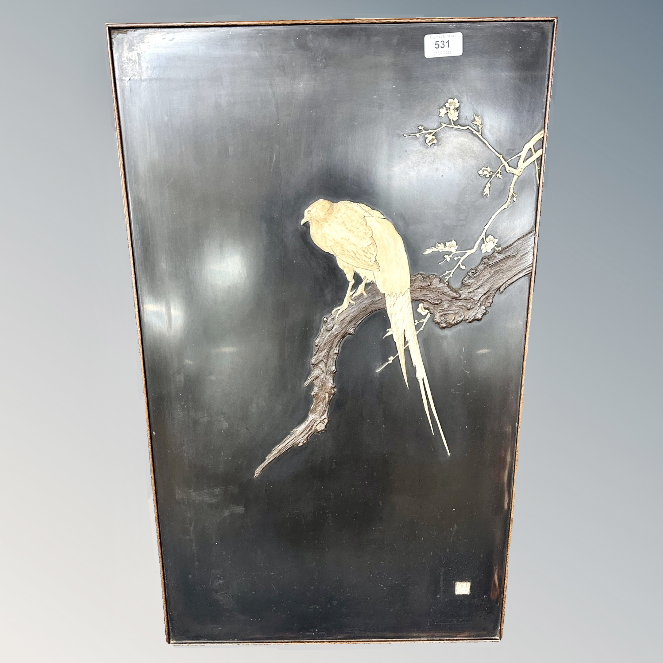 A Japanese Shibayama lacquer relief panel depicting a bird on a branch 46 cm x 76 cm