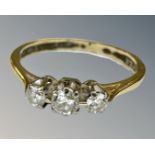 An 18ct gold three stone diamond ring, size L.