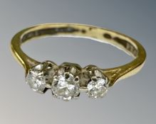 An 18ct gold three stone diamond ring, size L.