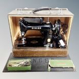 A vintage Singer 99K sewing machine with accessories, in case,