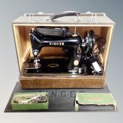 A vintage Singer 99K sewing machine with accessories, in case,