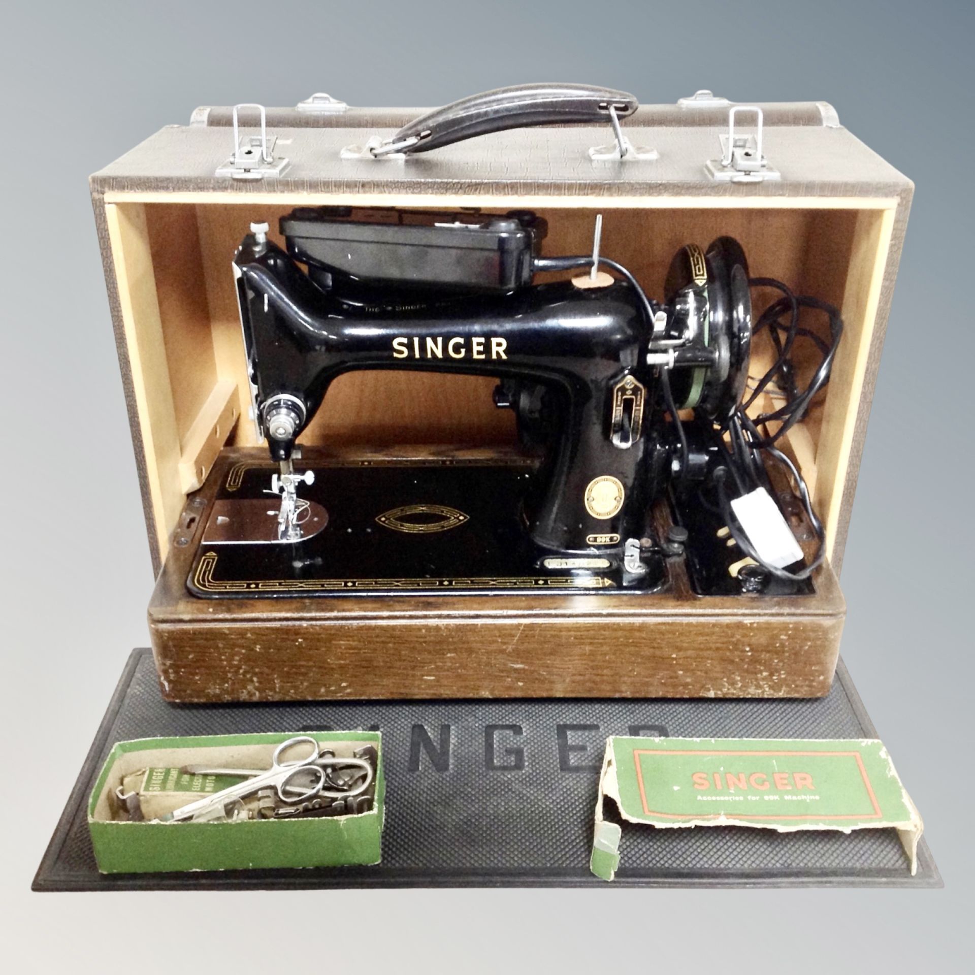 A vintage Singer 99K sewing machine with accessories, in case,