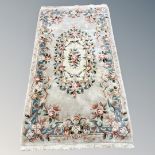 A Chinese floral rug on cream ground,