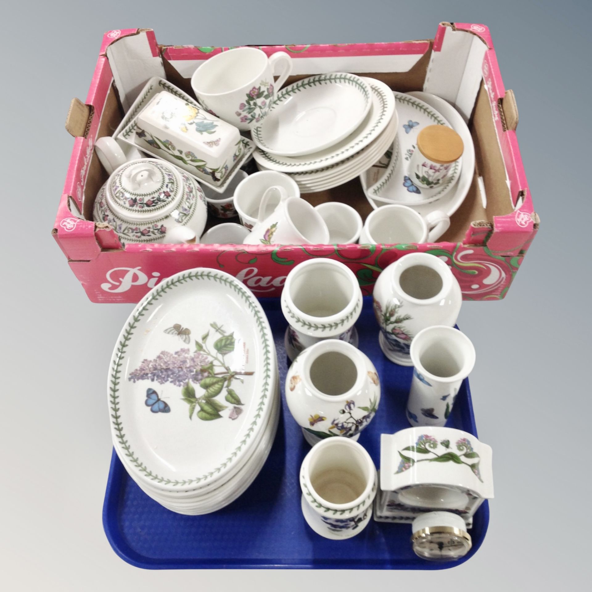 A box and tray containing floral pattern tea,