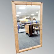 A wall mirror in oak faux bamboo frame