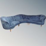 A contemporary three section shaped corner lounge suite in blue fabric