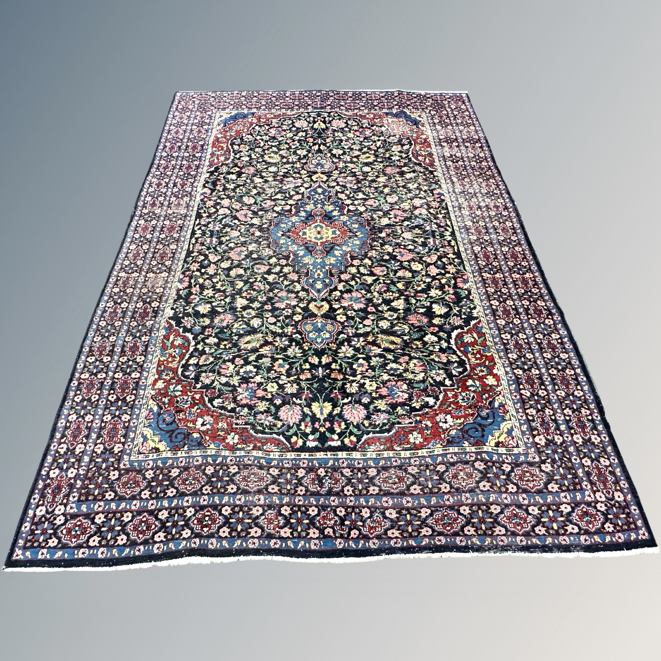 A Kirman carpet, South East Iran, 300cm by 216cm CONDITION REPORT: Thinning in areas,