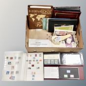 A box of albums of world stamps, First Day covers, loose stamps,