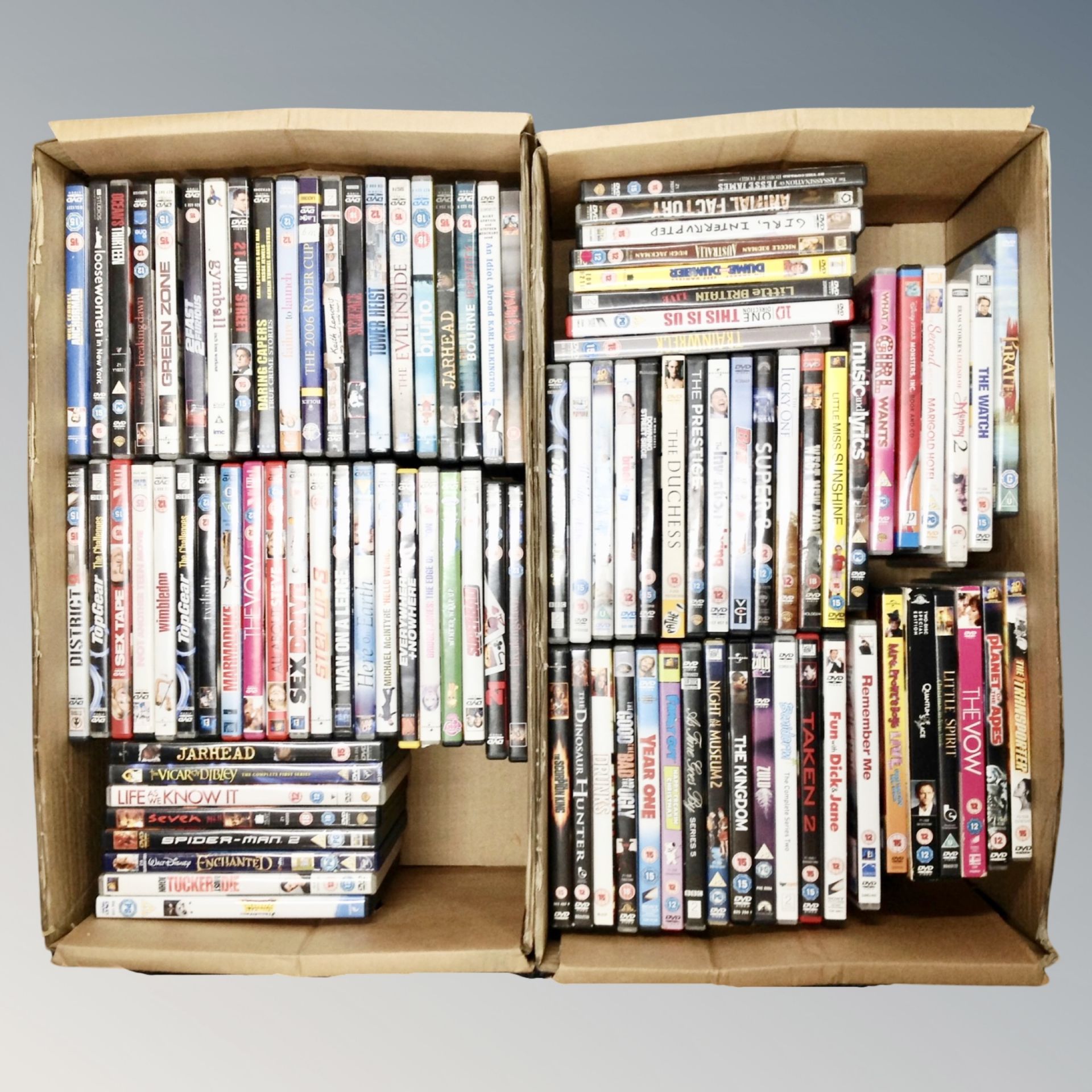 Two boxes containing approximately 100 dvds