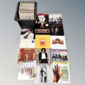 A crate of vinyl records to include Lindisfarne, Genesis, Wings, Elton John, John Lennon, The Jam,