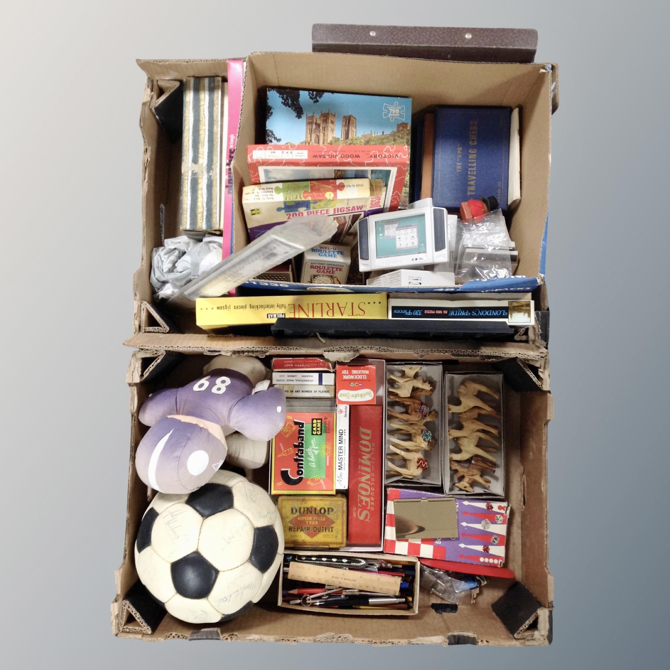 Two boxes of vintage jigsaws, card games, wooden camel ornaments, box of drawing instruments, ruler,