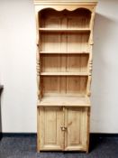 A set of vintage pine kitchen shelves fitted with cupboard beneath