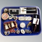 A tray of miniature metal tea service, pill boxes, Elthorp and Buckingham Palace boxed pens,