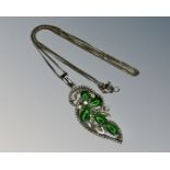 A 9ct white gold jade and diamond pendant on 14ct gold chain.