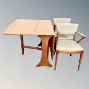 A 20th century teak G-Plan drop leaf table together with a pair of armchairs