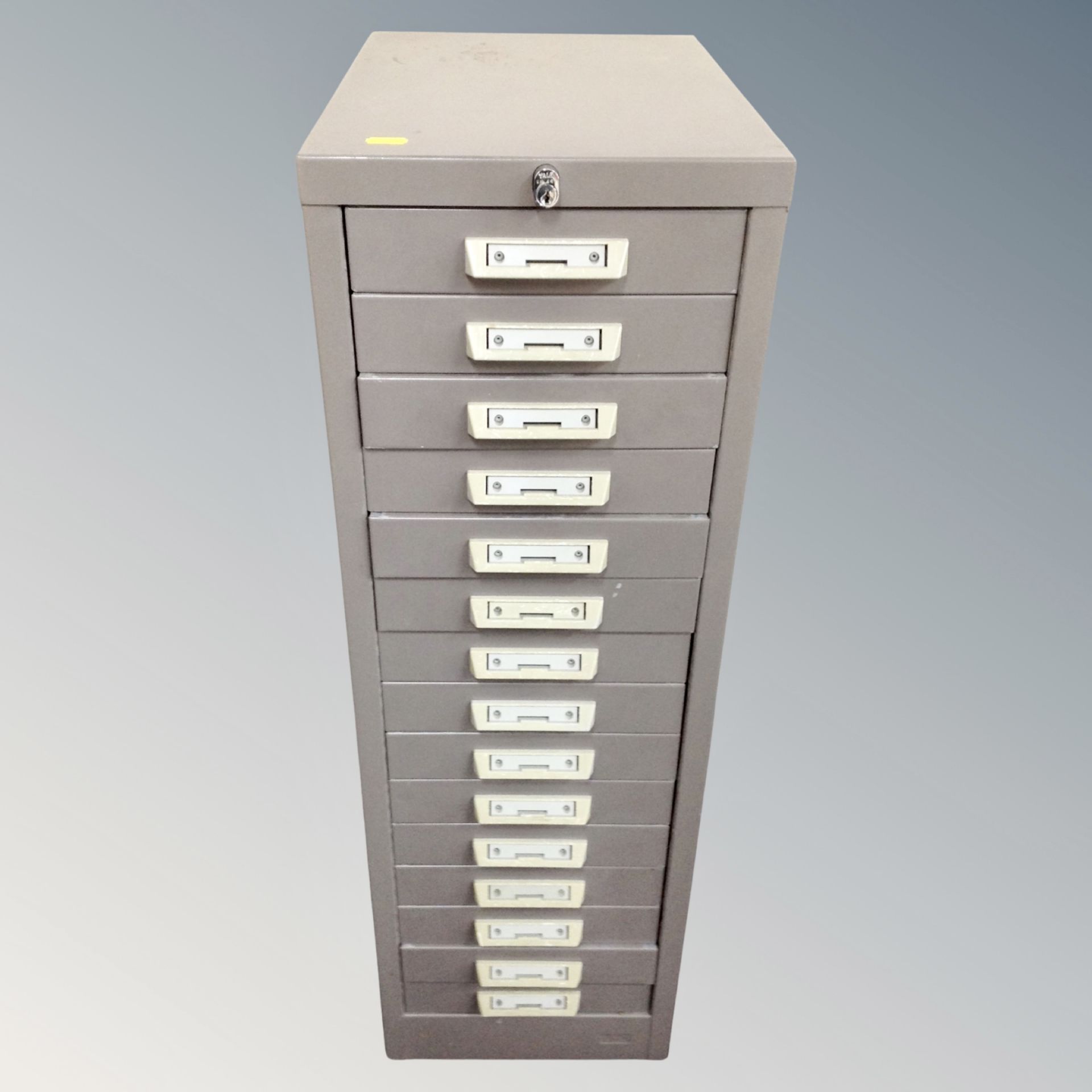A metal fifteen drawer filing chest , height 90 cm, width 29 cm depth 42 cm.