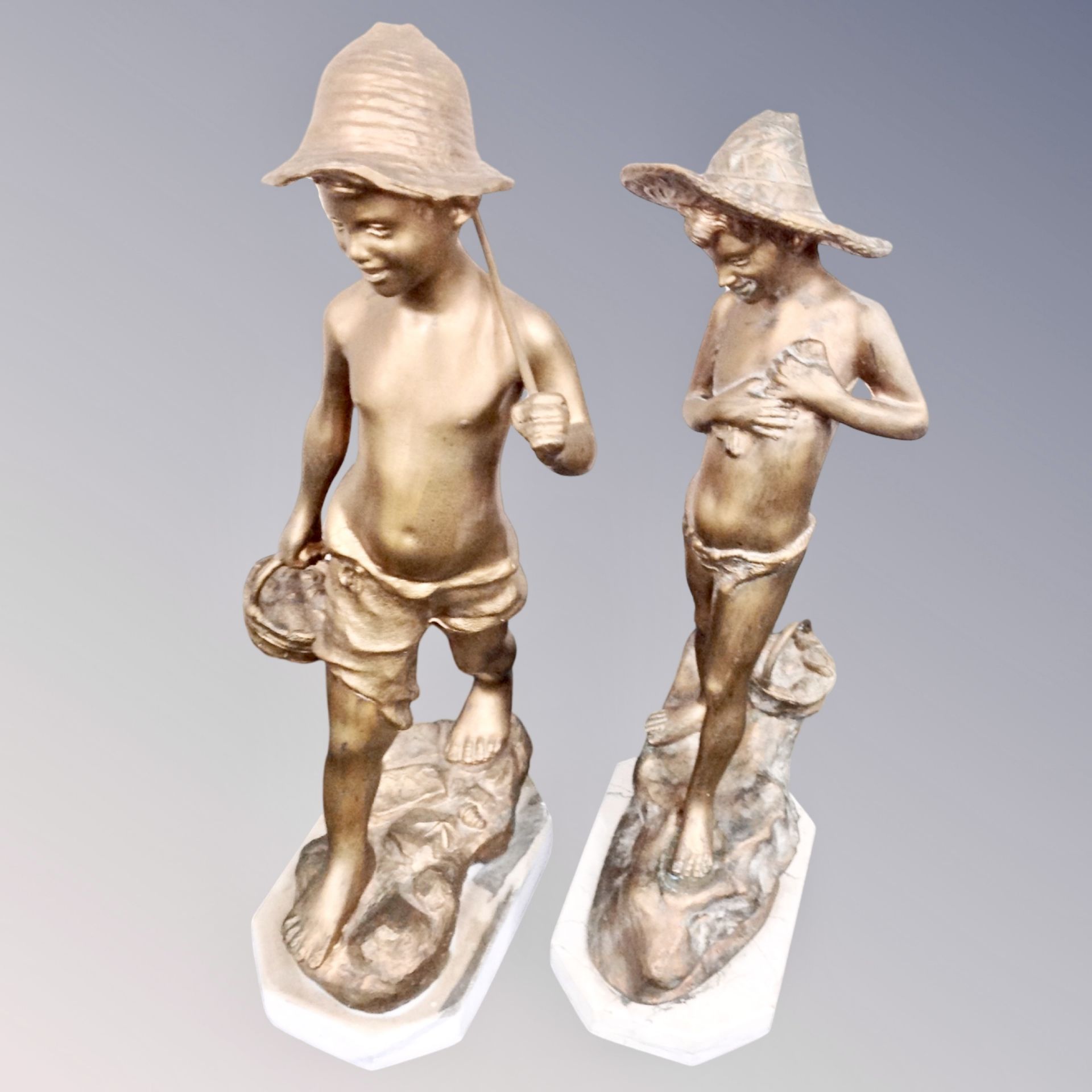 Two gilt spelter figures of fisher boys on plinths