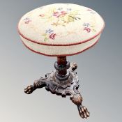 A 19th century heavily carved circular dressing table stool on carved tripod base