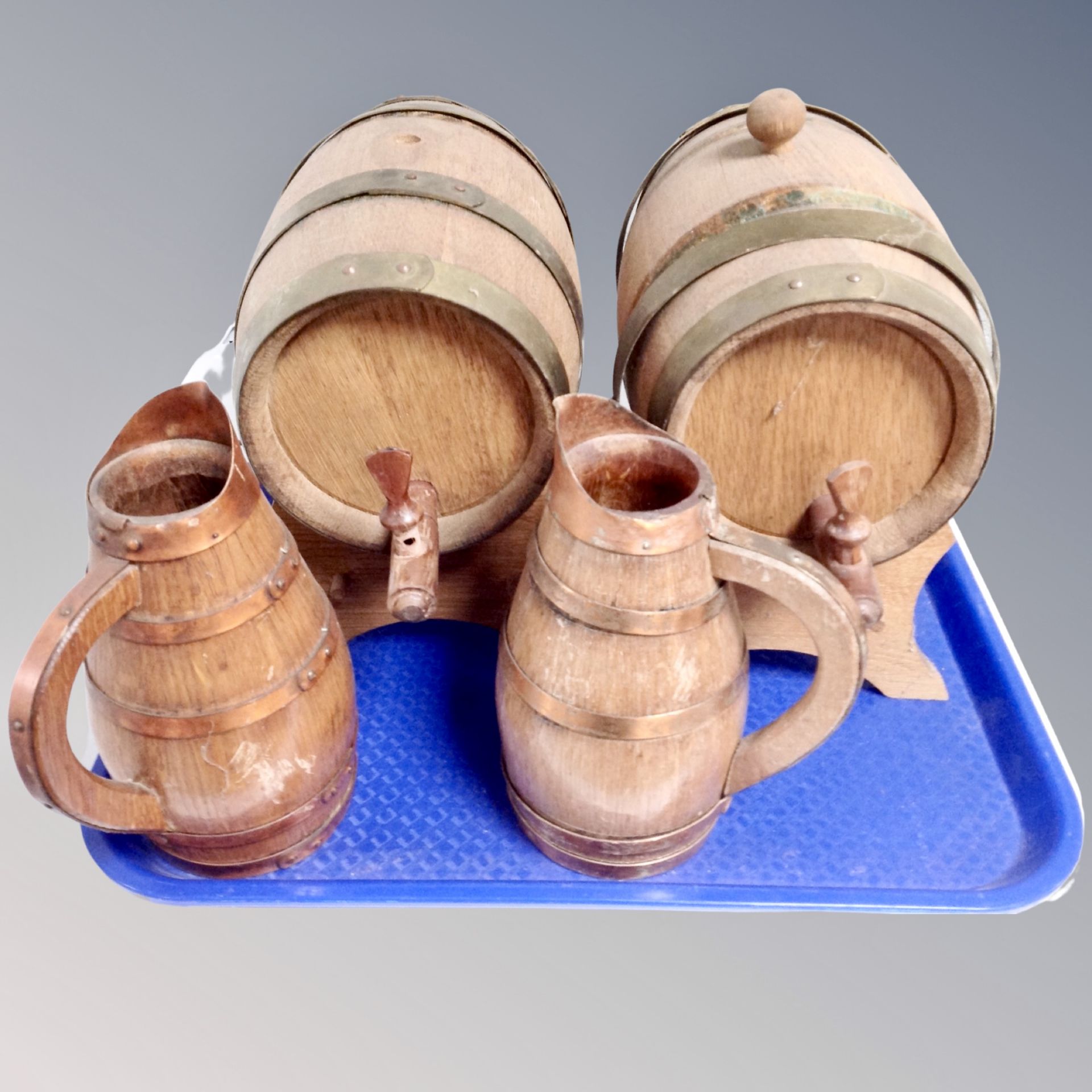 A tray of two vintage oak coopered barrels on stands together with pair of jugs