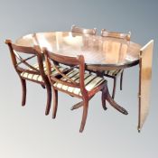 A Regency style twin pedestal dining table with leaf together with six chairs