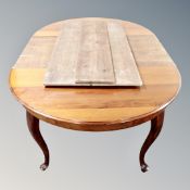 A 19th century circular mahogany dining table with three leaves