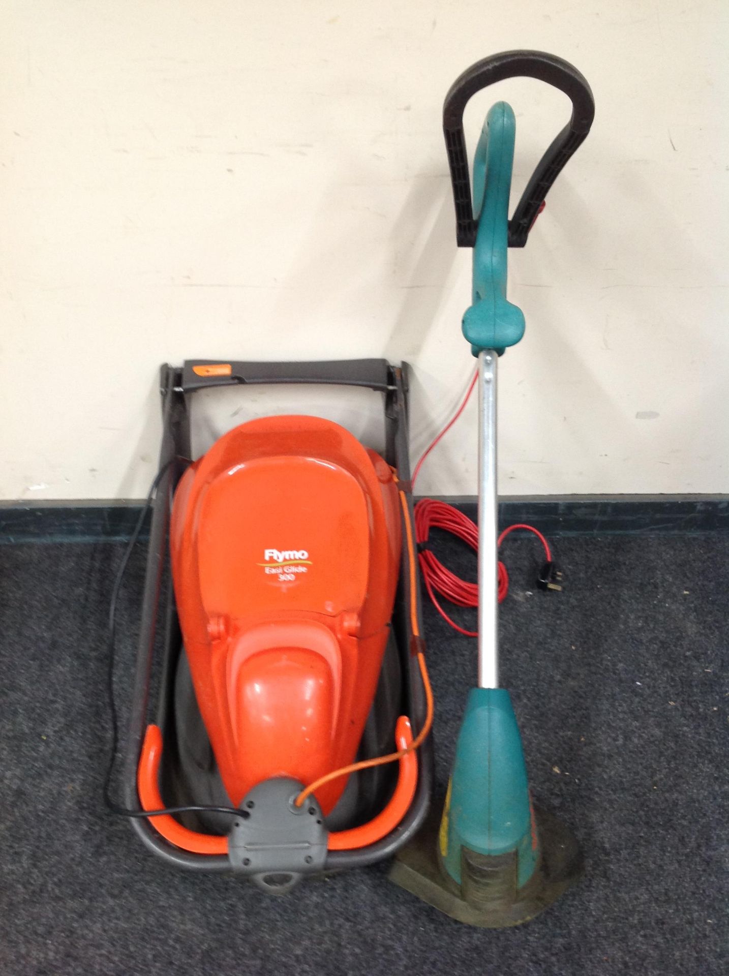 A Flymo Esi Glide 300 and a Bosch Art 25 GSAV strimmer