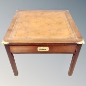 A campaign style occasional table with tooled leather top