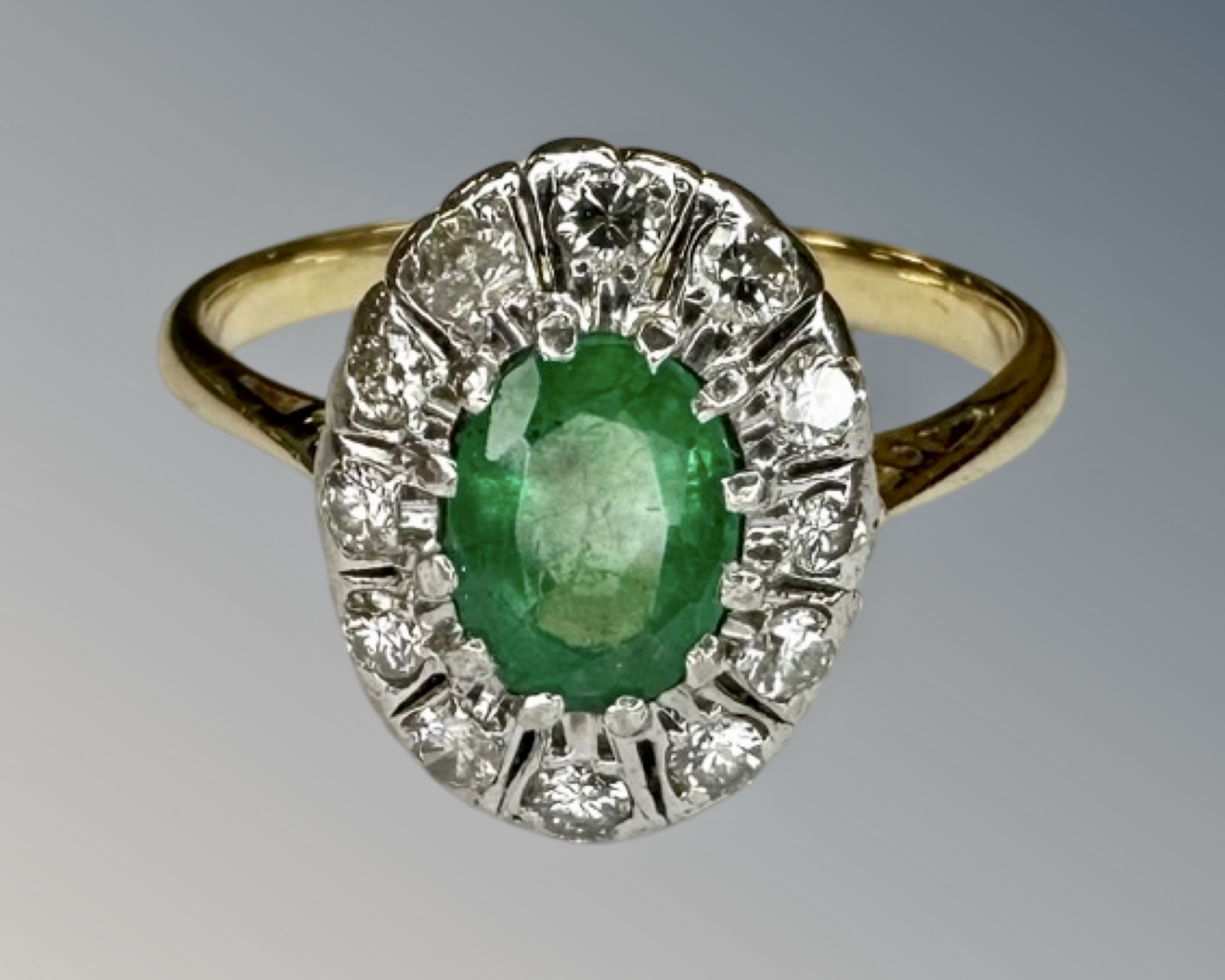 An antique 18ct gold emerald and diamond cluster ring, size O.