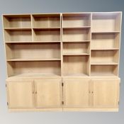 A 20th century Danish twin section shelving unit fitted with cupboards