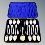 A Victorian cased set of twelve silver spoons, tongs and matching caddy spoon.