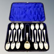 A Victorian cased set of twelve silver spoons, tongs and matching caddy spoon.