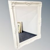 A traditional style bevelled mirror in cream frame,