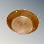 A vintage brass twin handled cooking pot, internal diameter 36.