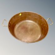 A vintage brass twin handled cooking pot, internal diameter 36.
