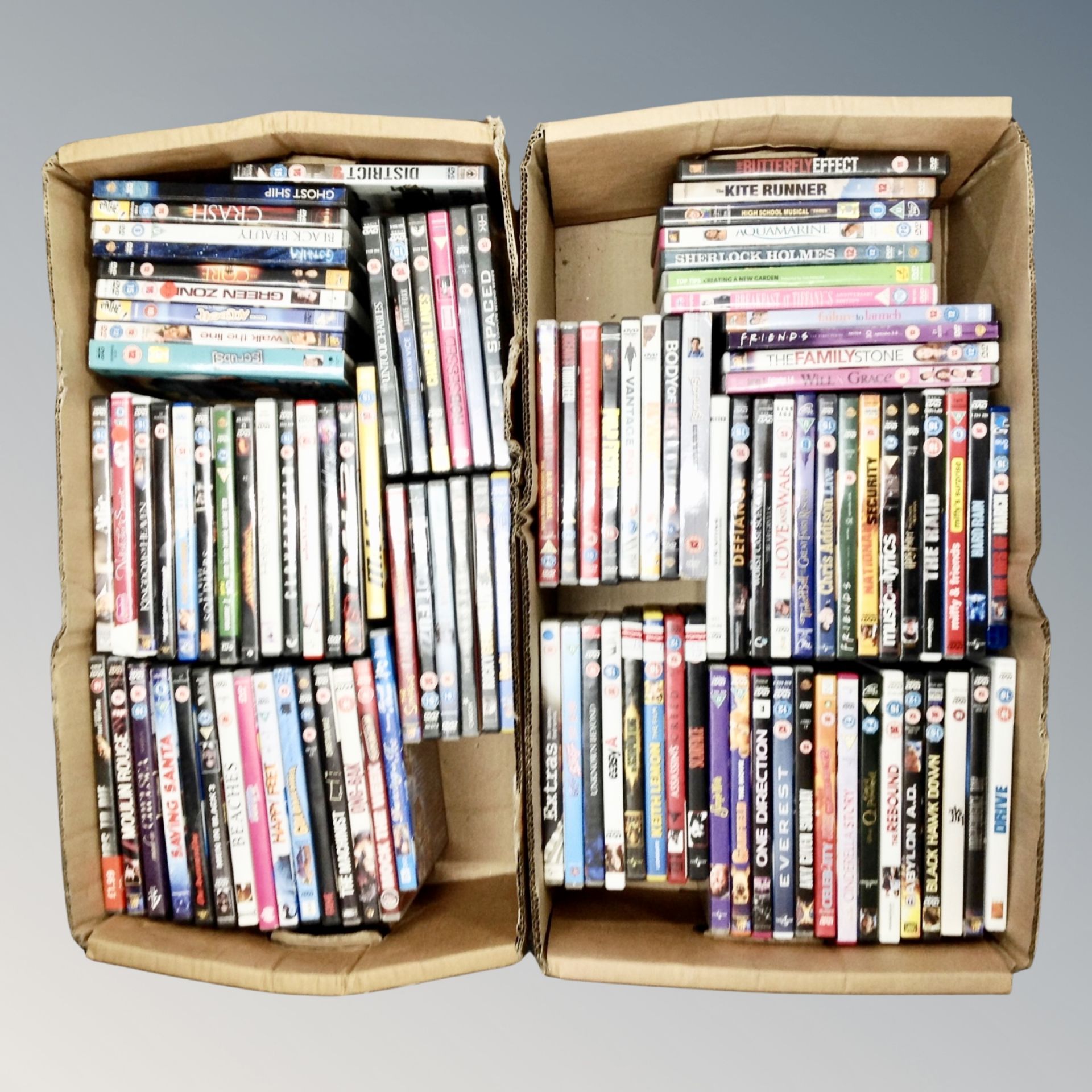 Two boxes containing approximately 100 dvds