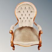 A Victorian style armchair in buttoned dralon
