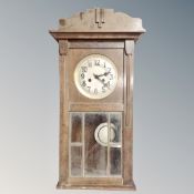 An early 20th century continental oak eight day wall clock