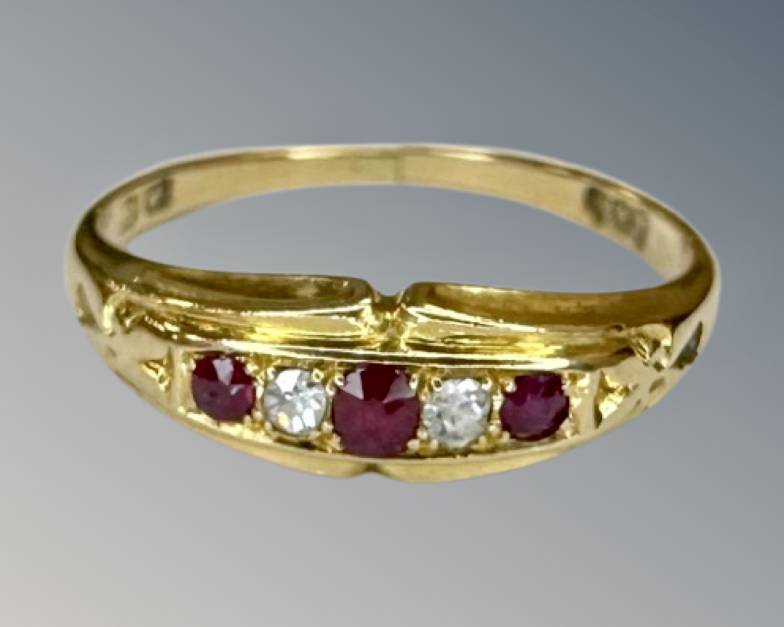 An 18ct gold ruby and diamond ring, size L½.