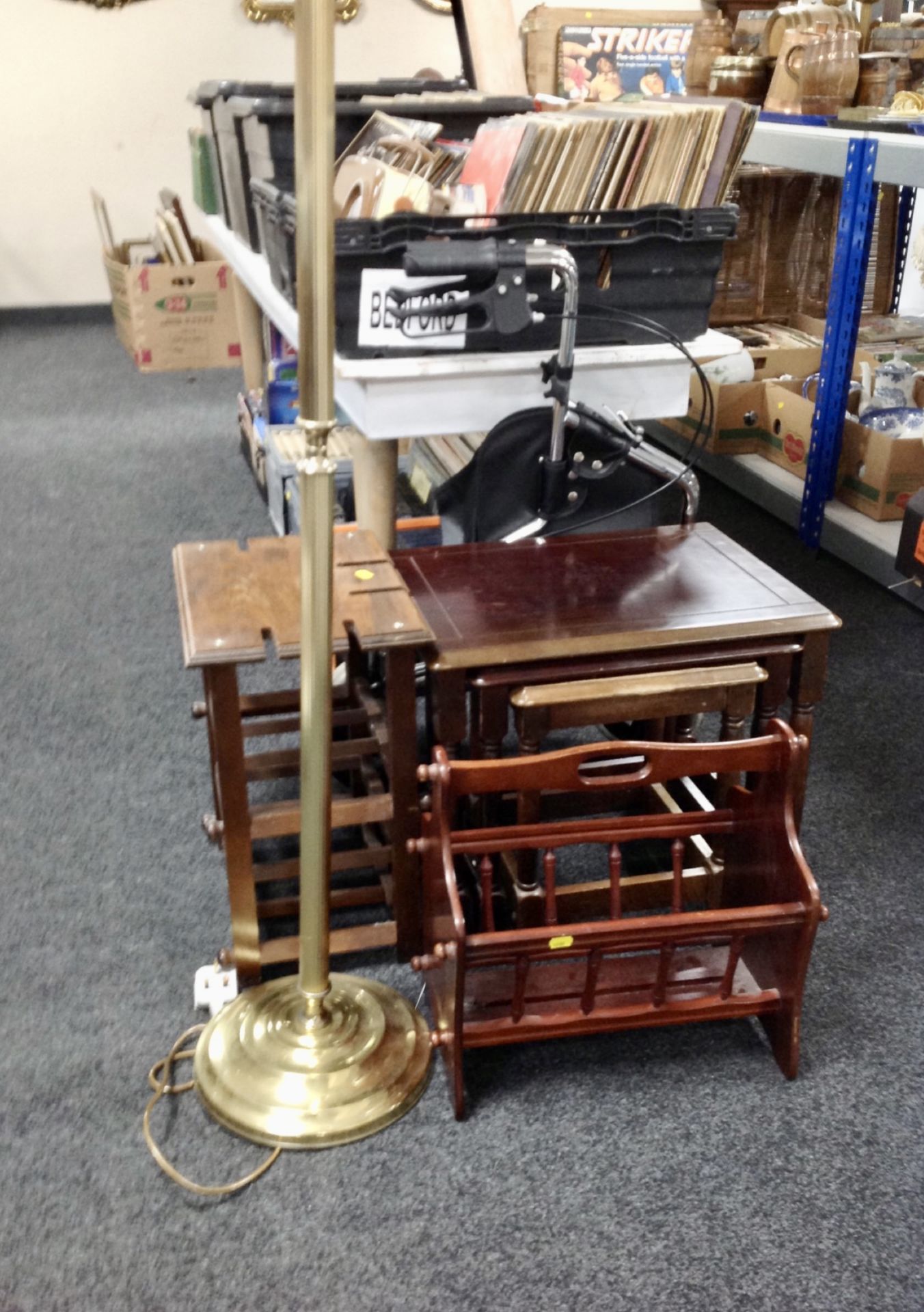 A brass column standard lamp and shade, mobility walking aid, wine rack,