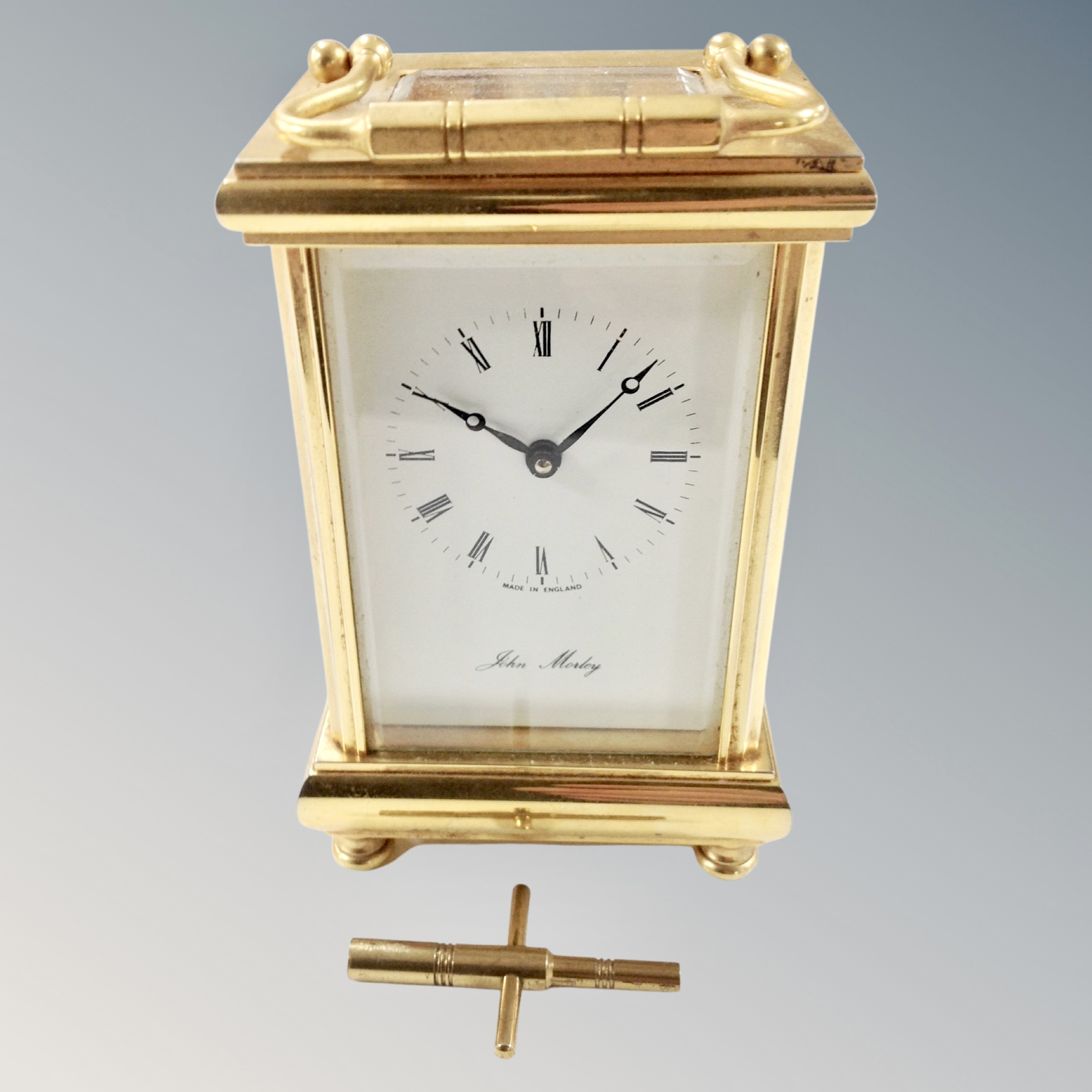 A brass eleven jewel carriage clock with key