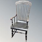 An antique painted spindle backed rocking chair
