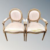 A pair of carved beech salon armchairs in striped fabric