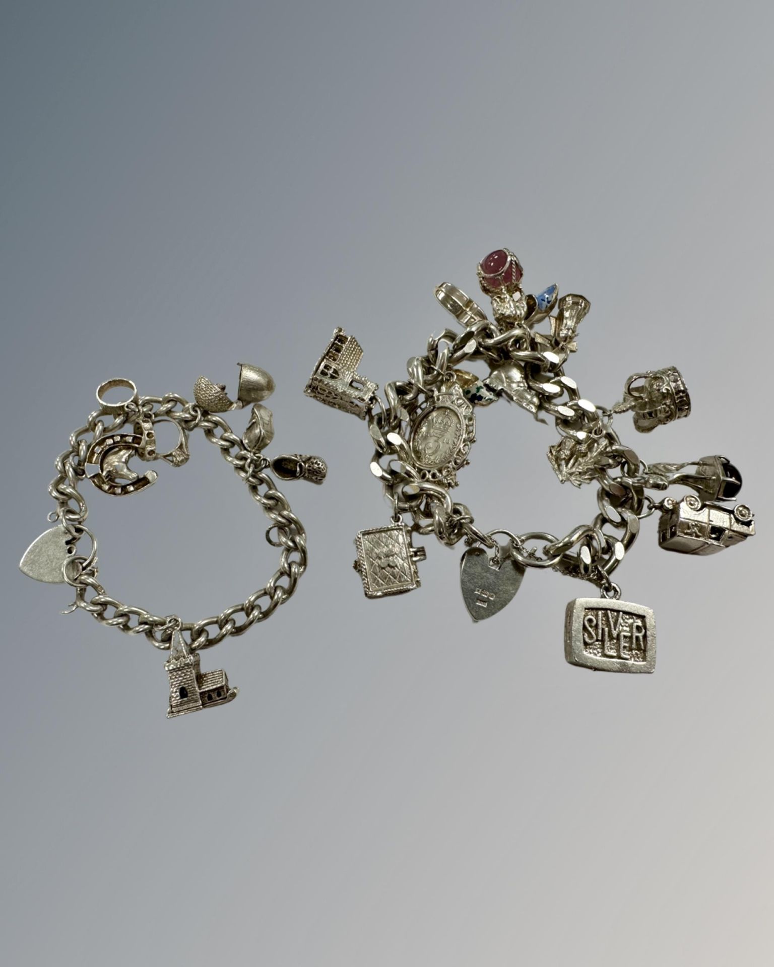 Two silver charm bracelets, 170g.