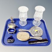 A tray of three piece white embossed metal dressing table set, blue glass perfume bottle,